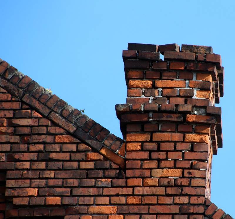 Damaged chimney on an Columbus home showing cracks and missing mortar